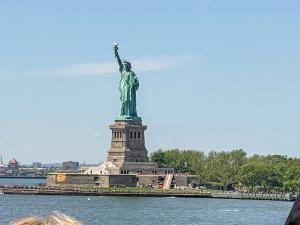 The Statue of Liberty with a ferry boat in the foreground