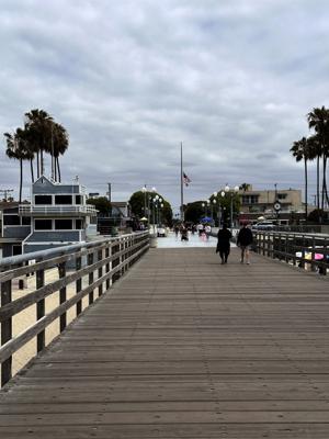 A long perspective view of the wooden planks on Seal Beach Pier